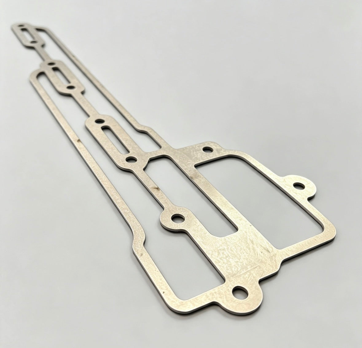 C910E1468/1MM>6MM - Gasket-Scavenge Manifold 1mm to 6mm