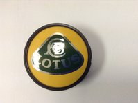 A green and yellow wheel centre cap with a Lotus roundel logo.